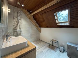 a bathroom with a white sink and a window at Chez escarain in Arette +47 photos