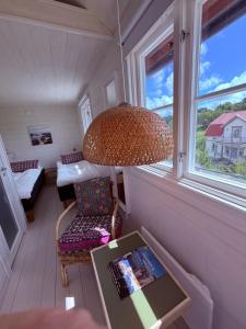 a room with a table and a chair and a lamp at Hem till Bengt in Kungshamn