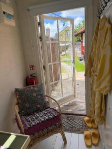 a wicker chair with a pillow sitting in front of a door at Hem till Bengt in Kungshamn