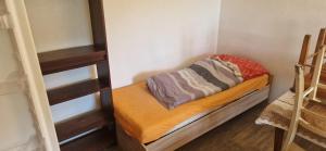 a small room with a bunk bed and a ladder at Nová Paka 1402 in Nová Paka