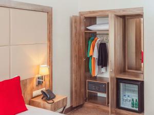 a bedroom with a bed and a mirror and a closet at ibis Styles Istanbul Bomonti in Istanbul