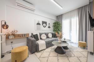 a living room with a couch and a table at West Athens Luxurius Apartment in Athens