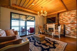 a living room with a couch and a fireplace at Poison Garden Suite & SPA in Gözalan