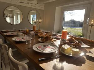 a dining room table with food on it at La Corti in Tillières-sur-Avre