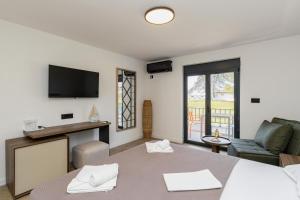 a living room with a bed and a couch at FKK Ada Bojana in Ulcinj