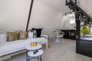 a living room with a couch and a table at Danae's A-Frame Nest in Daratso
