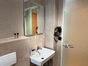 a bathroom with a white sink and a mirror at Ritson Hotel in Vlorë +40 photos