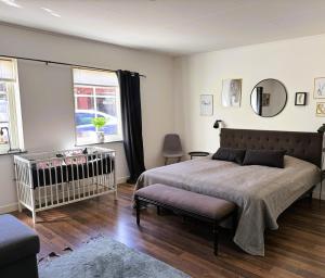 a bedroom with a large bed and a crib at Ängshöjd in Sandhem +48 photos