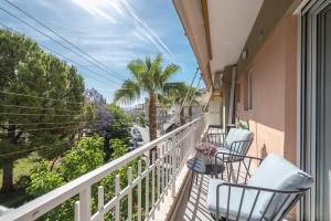 a balcony with chairs and a view of a street at West Athens Luxurius Apartment in Athens
