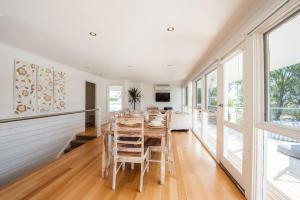 a dining room with a table and chairs at Bella Vita Beach House in Robe