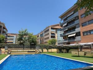 a large swimming pool in front of a building at Apartment in Castelldefels! in Castelldefels