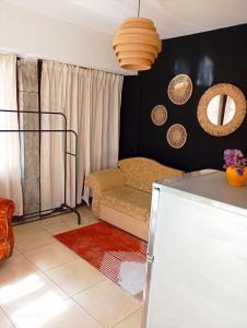 a living room with a couch and a table at Rise And Shine Rooms Korca in Korçë