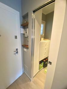 a room with a closet with a mirror and a door at Bright and silent studio in Bardonecchia centre in Bardonecchia