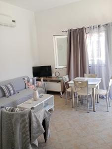a living room with a couch and a table at Eleni House in Didyma