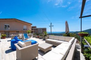 a patio with a couch and chairs on a balcony at Apartments Horizont in Budva