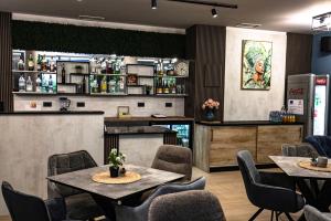 a restaurant with tables and chairs and a counter at Philippopolis Hotel in Plovdiv