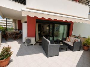 a patio with two chairs and a couch and a table at Blue Horizon SKG in Thessaloniki