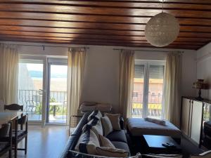 a living room with a couch and a table at Dramalj apartman 4+1 in Dramalj