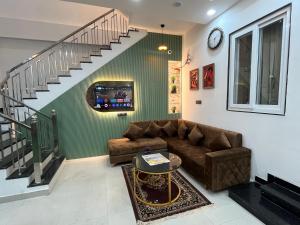 a living room with a couch and a staircase at Hotel Chunda Niwas in Dabok