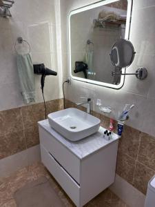 a bathroom with a white sink and a mirror at У Эльмана in Sumqayıt +19 photos