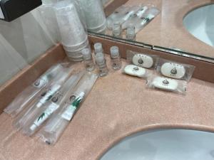 a bunch of toothbrushes in a sink in a bathroom at Hotel Sirena & Cucina in Cesenatico +55 photos