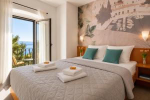 a bedroom with a large bed with towels on it at Hotel Kastil in Bol