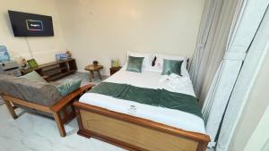 a bedroom with a bed and a chair in it at Wattle Residence Ngong in Ngong