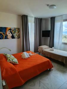 a hotel room with two beds and a window at AmarMare Bed&Breakfast in Trappeto