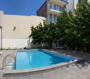 a swimming pool in front of a building at Wave Inn boutique in Yerevan