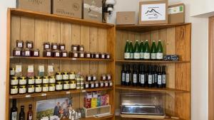 a store with many bottles of wine on shelves at Albergo Garnì Casa del Lago in Tenno