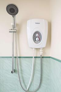 a shower in a bathroom next to a shower at Miracle holiday homestay in Demodera +2 photos