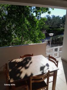 a table and chairs on a balcony with a view of a yard at Vieste Residence Gallo Con Piscina in Vieste
