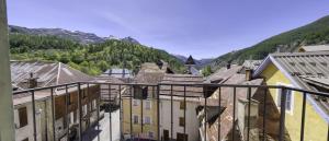 a view of a town with mountains in the background at Hotel pascal in Allos