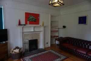 a living room with a couch and a fireplace at Torridon Estate B&B Rooms and Self catering Holiday Cottages in Torridon