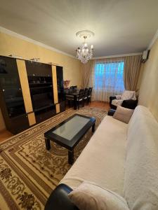 a living room with a couch and a table at Lankaran house in Lankaran +3 photos