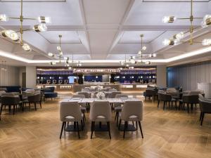 a restaurant with tables and chairs and a wine cellar at Mercure Shanghai Yu Garden On the Bund - 5 mins taxi to Nanjing Road and Bund in Shanghai