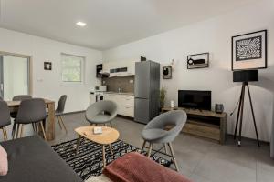 a living room with a couch and chairs and a television at Apartmány Miromar in Podivín