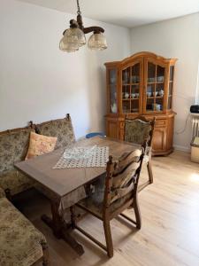 a dining room with a wooden table and chairs at Roxy in Beverungen +6 photos