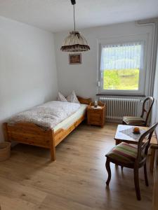 a bedroom with a bed and a table and a window at Roxy in Beverungen