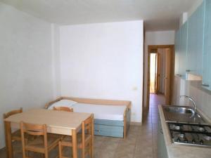 a small kitchen with a table and a bed in a room at Vieste Residence Gallo Con Piscina in Vieste +11 photos