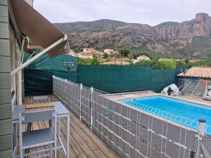 a balcony with a pool and a table and a chair at Ribella in Appietto