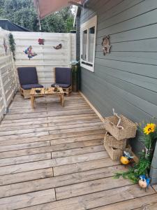 a deck with two chairs and a table on a house at Ribella in Appietto