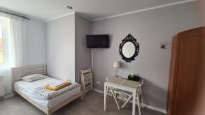 a bedroom with a bed and a table and a mirror at ALDAMI in Warsaw +63 photos