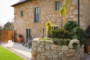 a stone wall in front of a house at BaguHouse in Pombal