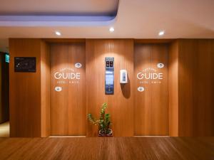 a row of lockers with a cell phone on the wall at Guide Hotel Taoyuan Fuxing in Taoyuan