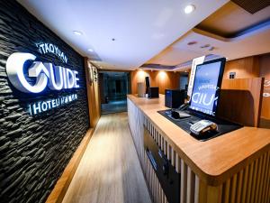 a lobby of a hotel cubicle with a computer on a counter at Guide Hotel Taoyuan Fuxing in Taoyuan