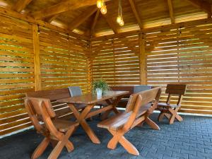 a wooden table and chairs in a wooden cabin at Noclegi u Eweliny in Zator