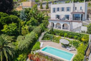 an aerial view of a house with a swimming pool at Villa Donatella - Lake Como Infinity Pool & Private Spa in Gravedona