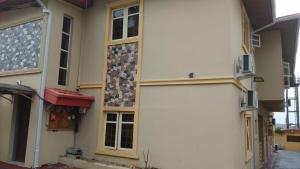 a white building with a bunch of windows on it at Three bedroom apartment Magodo GRA in Magodo