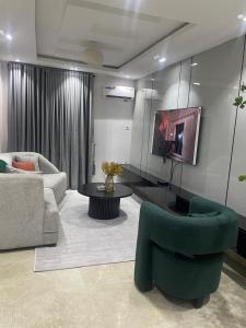 a living room with a couch and a table and chairs at Three bedroom apartment Magodo GRA in Magodo +4 photos